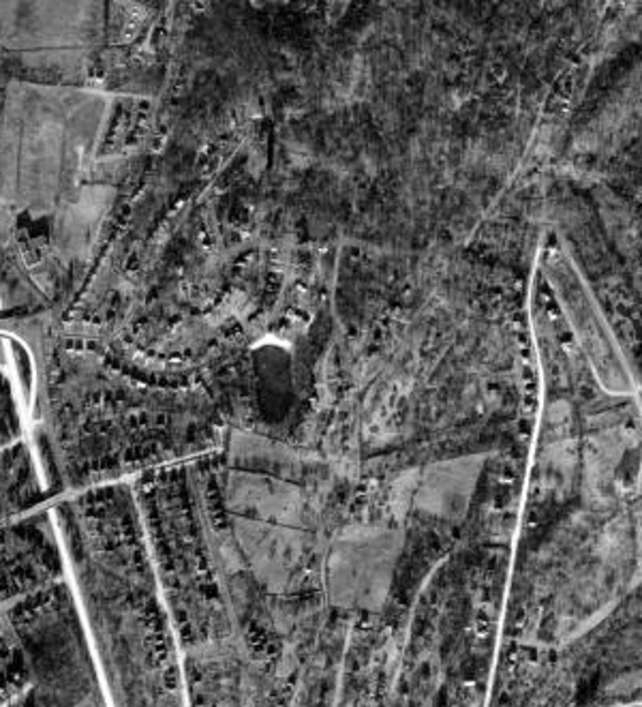 1940 aerial photograph showing the pond among neighborhood roads and houses