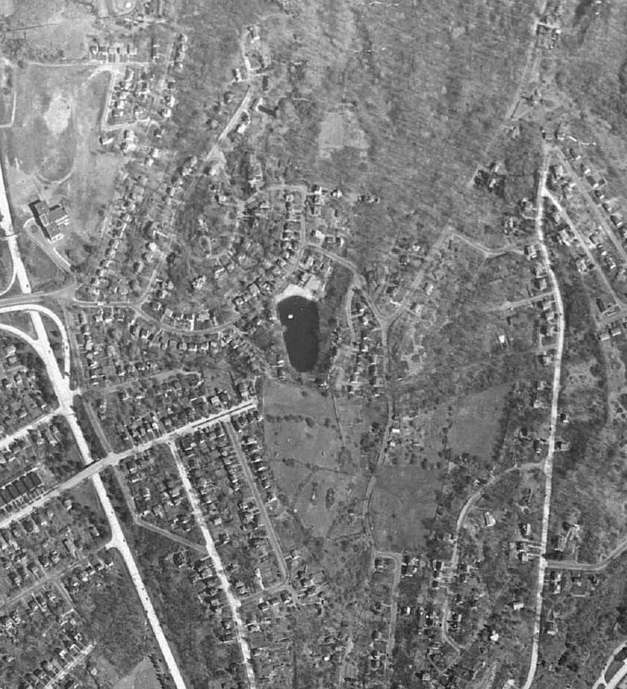 1954 aerial photograph showing the pond surrounded by houses